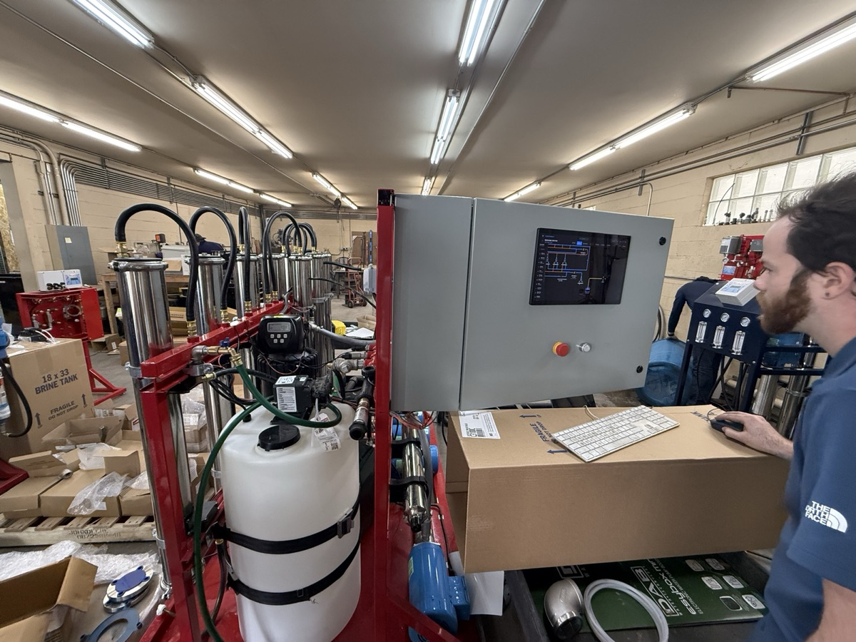 Technician operating the Guardian HMI panel installed on the machine